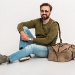 hansome bearded stylish man sitting on floor u8c62kr